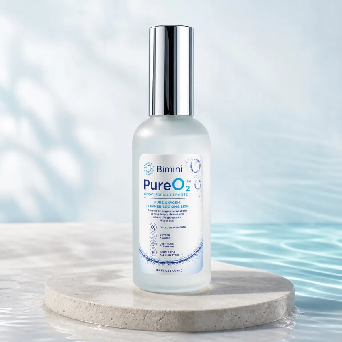 Bimini Pure O2 Spray bottle on a stone plinth beside clear water
